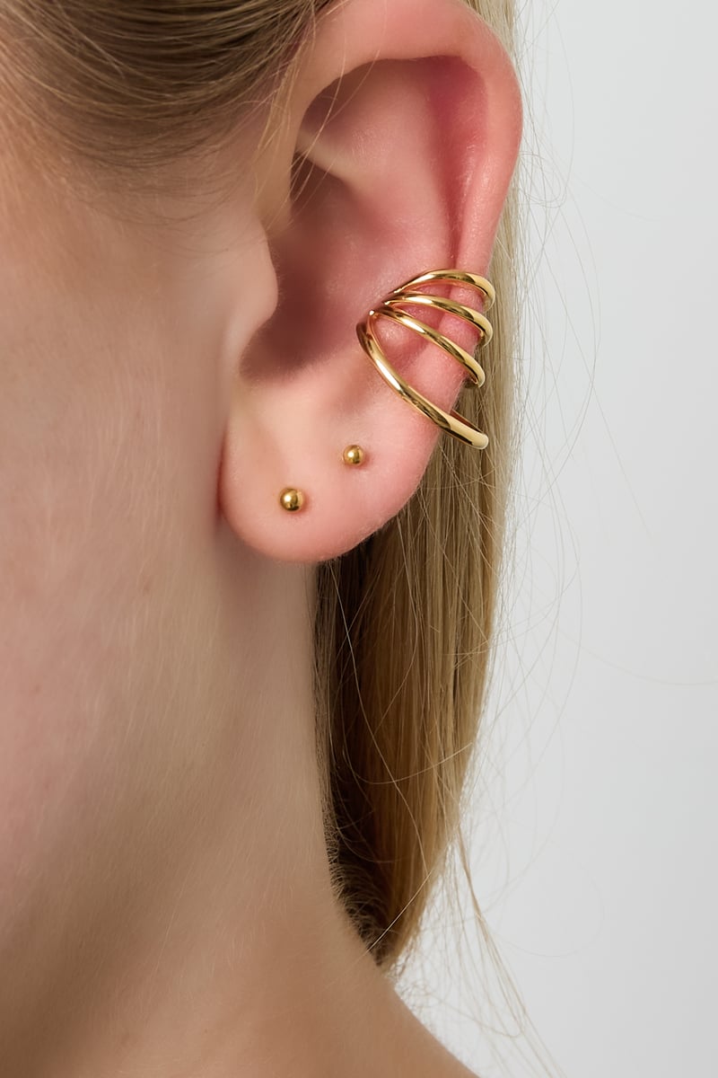 copper geometric ear cuffs worn on model’s ear