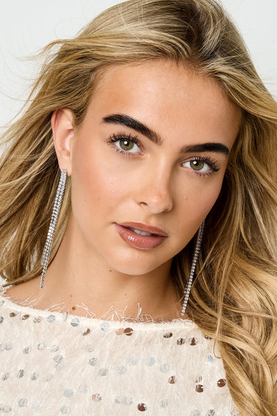 geometric copper dangle earrings worn on ear